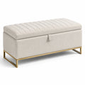 Banc de rangement en tissu beige avec structure en métal doré